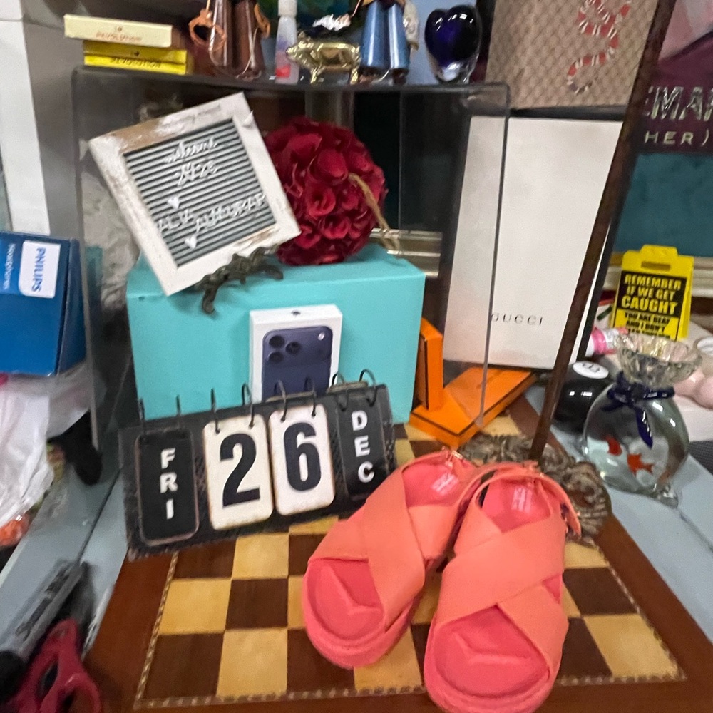 Rockfish sandals in a coral or pinkish-orange color.